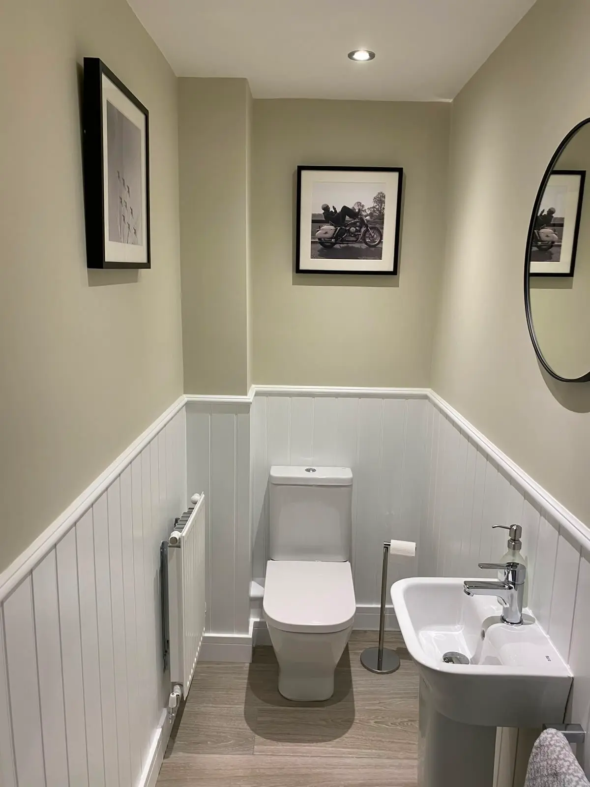 White tongue-and-groove boarding to dado height around a cloakroom, finished with a capping rail and returned around the reveals.