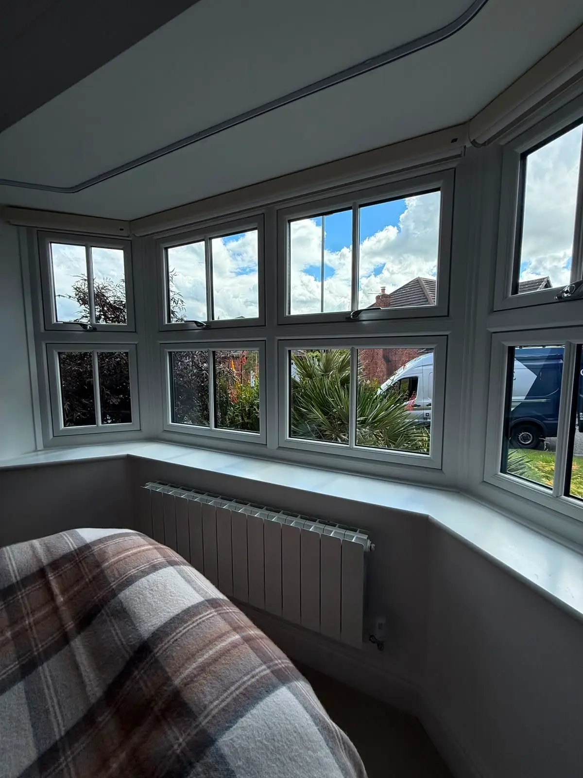 The same kind of bay seen from inside a bedroom, showing the casements, the boxed-out reveal and the full-width painted window board.
